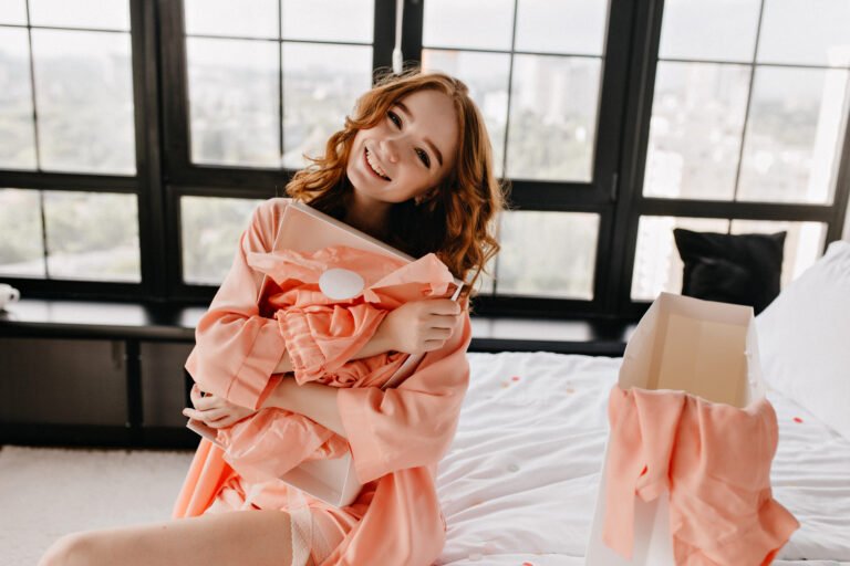 Appealing red-haired girl posing in bedroom